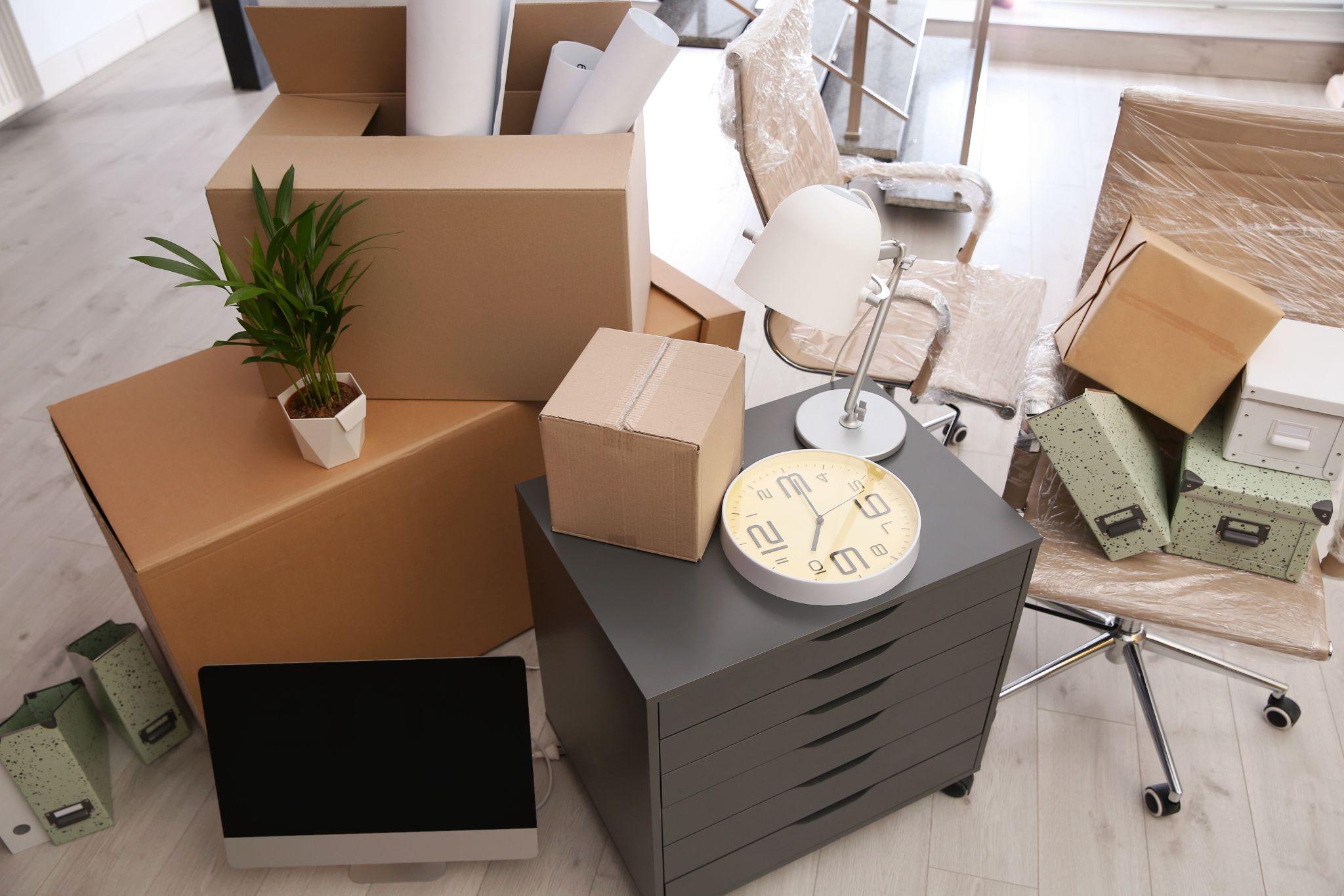 Office packed up with boxes, monitor, and equipment - business hurricane preparedness