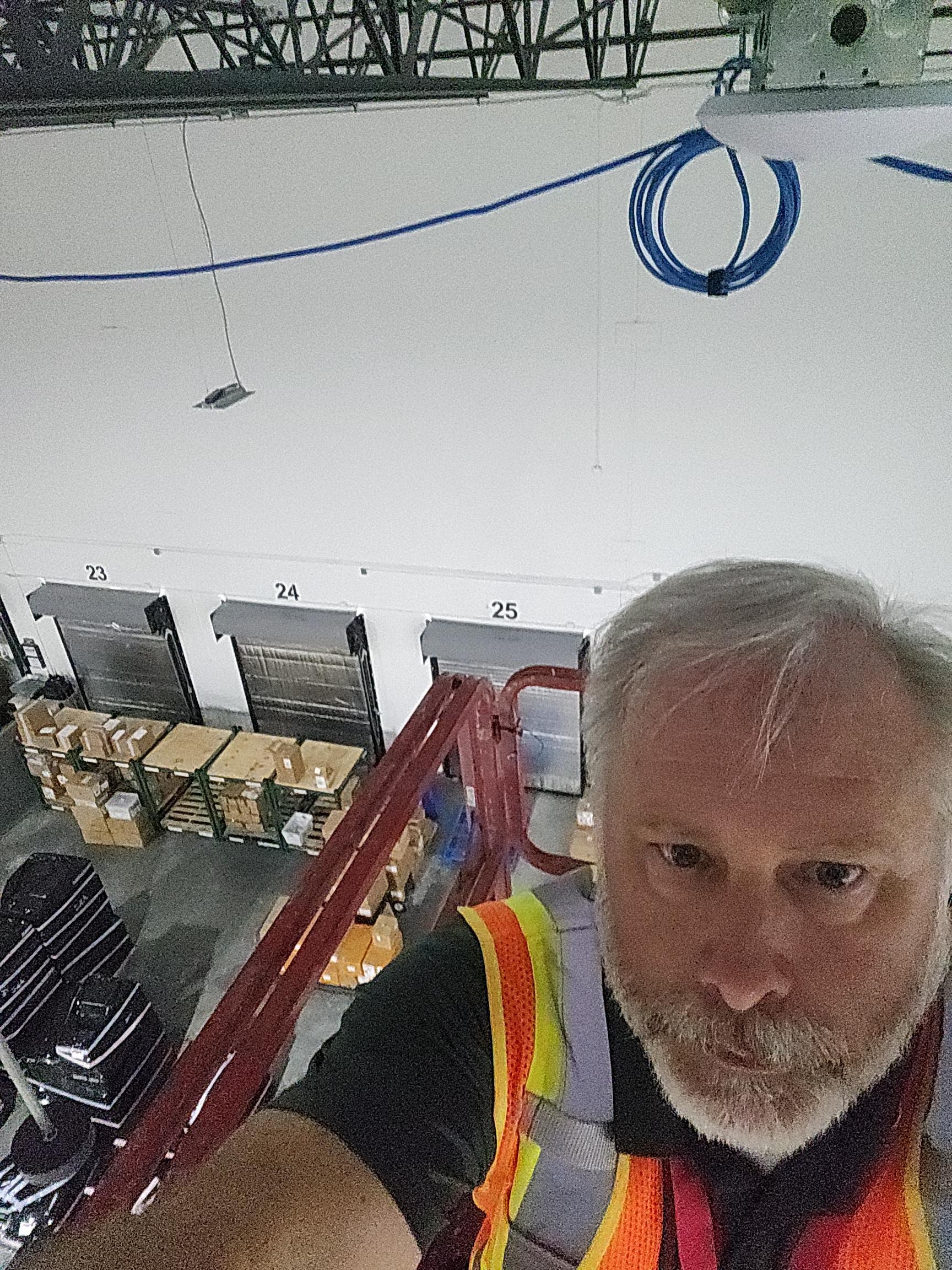 Dennis Shelton installing wireless access point - hands-on leadership
